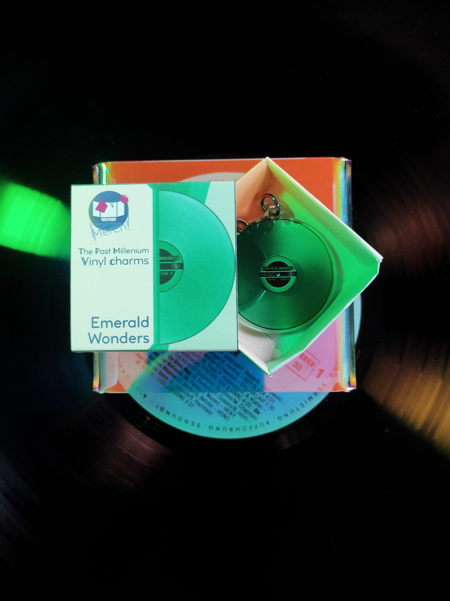 Green vinyl record with packaging labeled 'Emerald Wonders' on a dark background