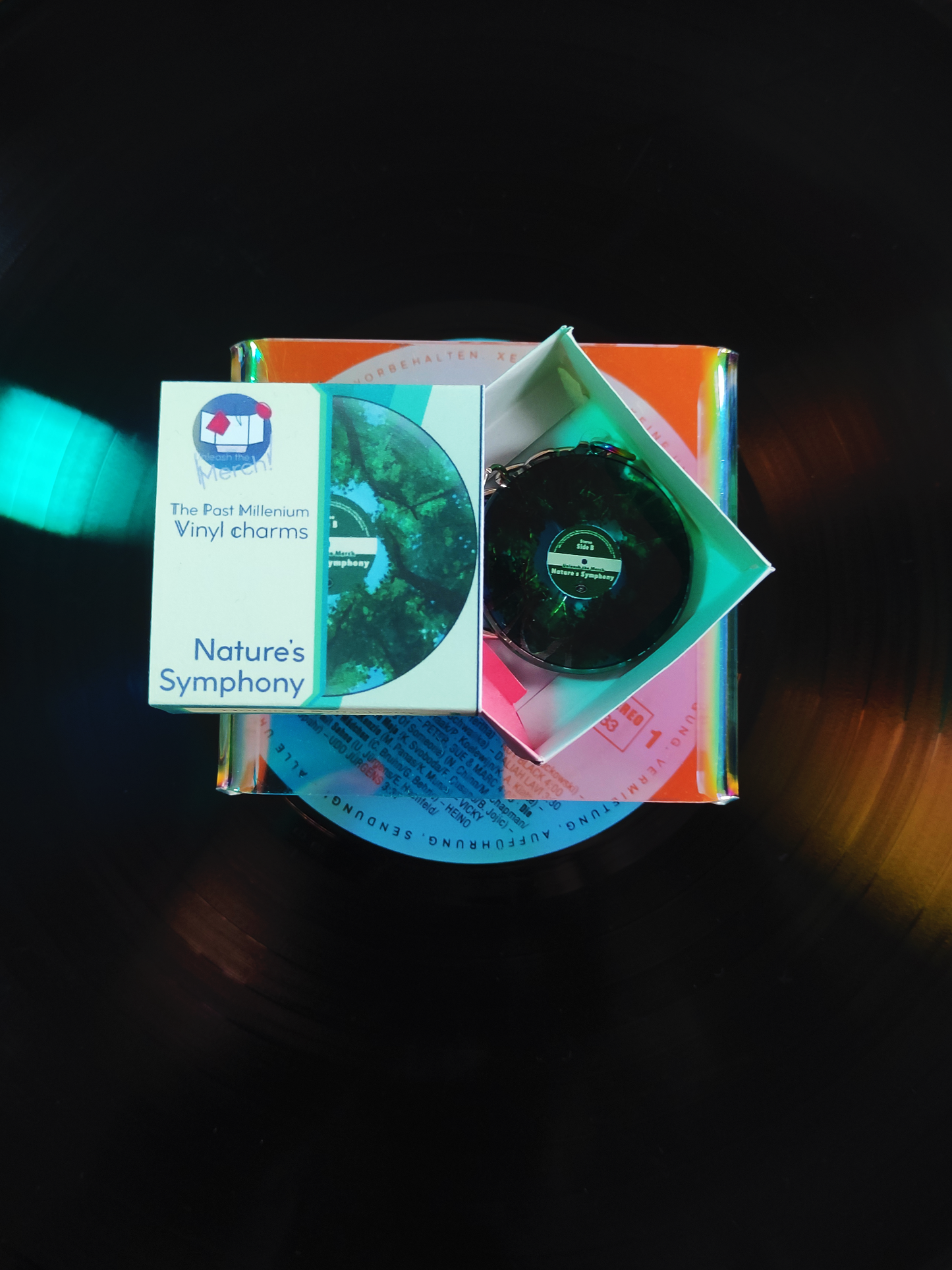 Vinyl charm in its box on a dark background