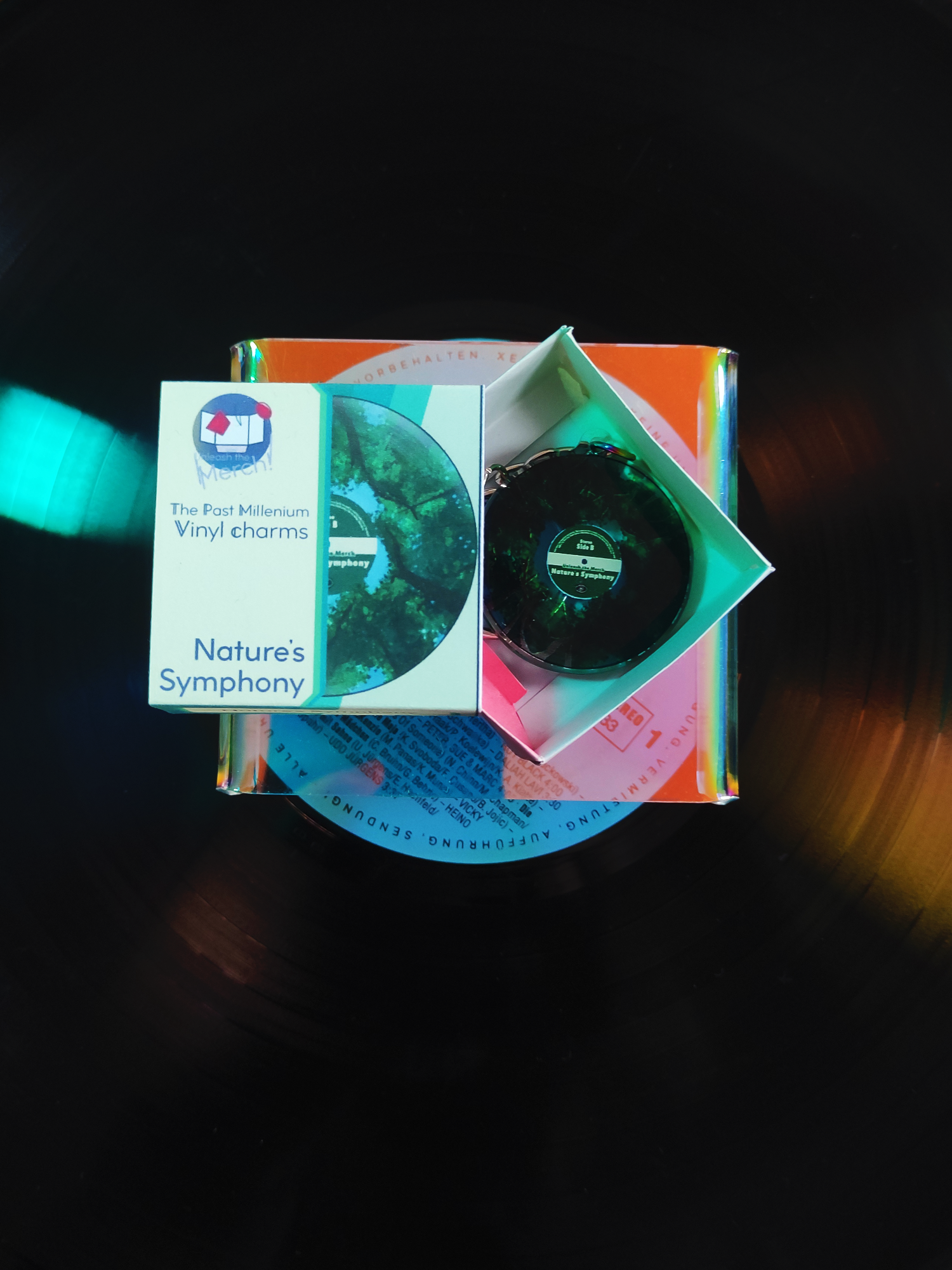 Vinyl charm in its box on a dark background