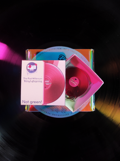 Pink vinyl record with packaging on a dark background