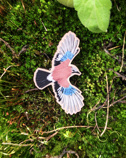 Wooden pin of a Eurasian Jay on moss.