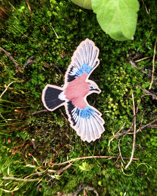 Wooden pin of a Eurasian Jay on moss.
