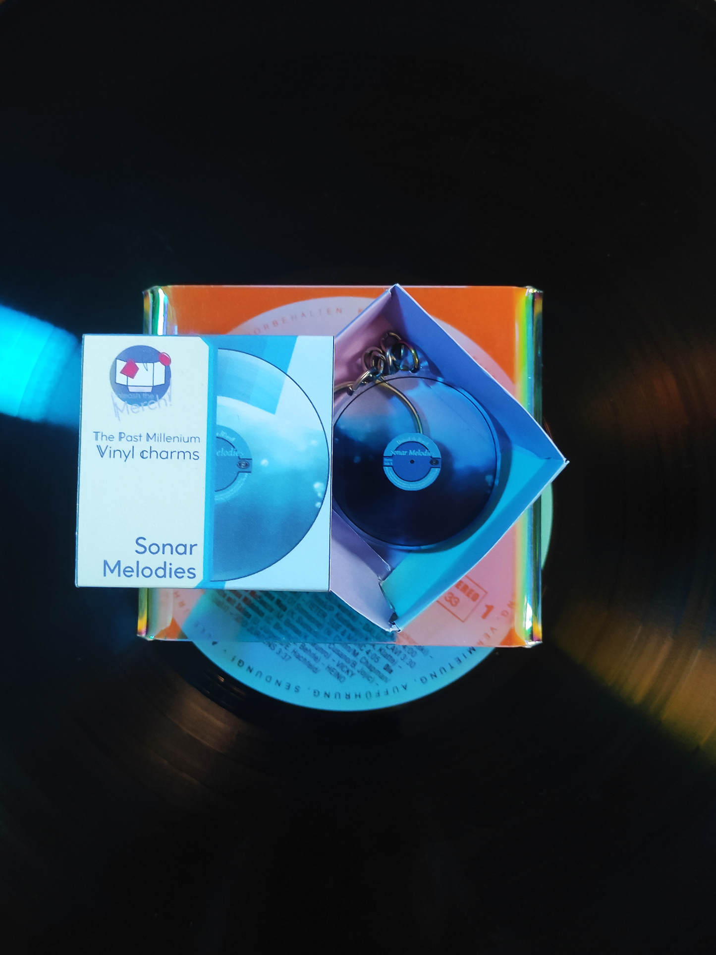 Blue vinyl record packaging on a dark background