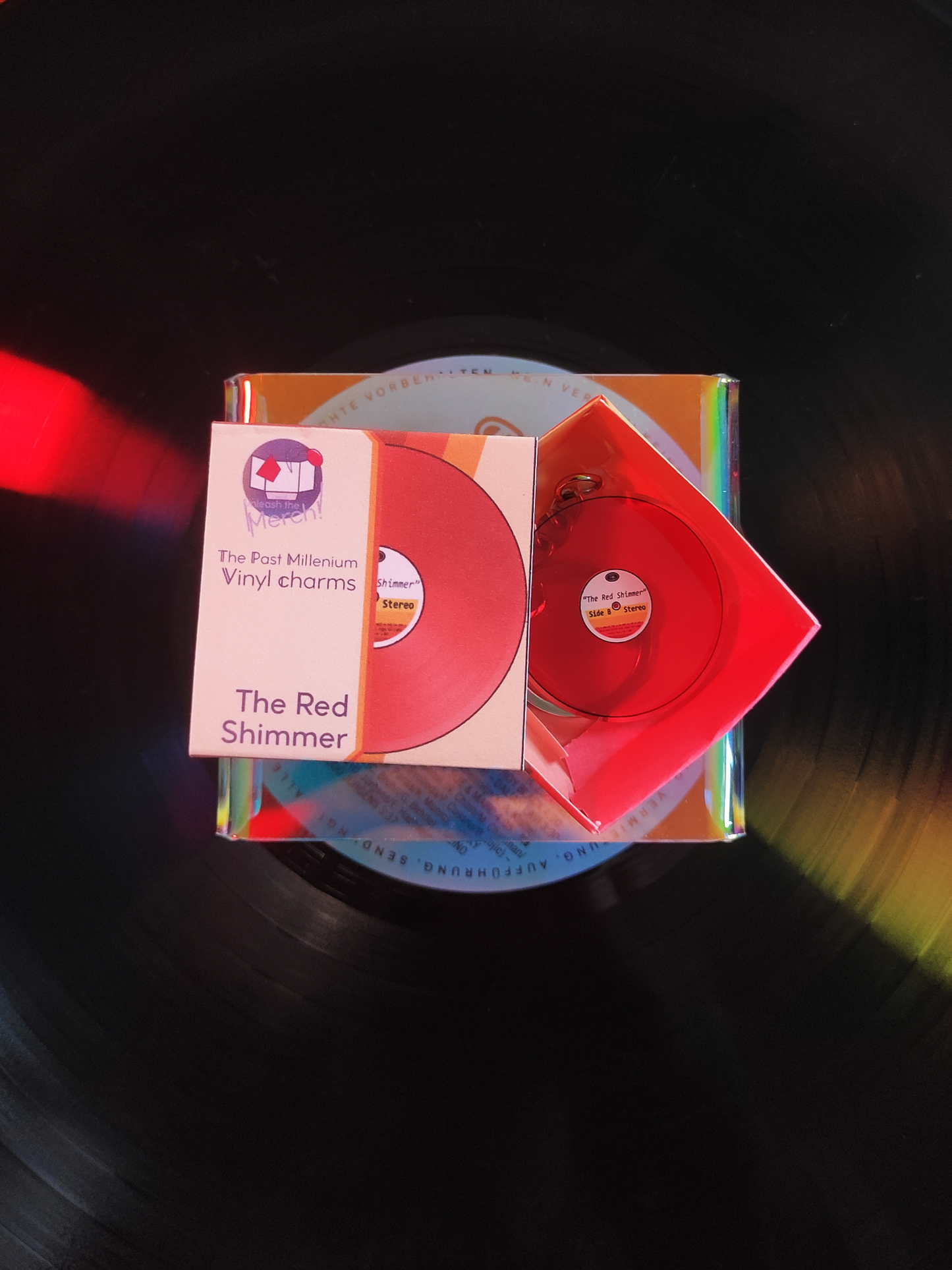 Red vinyl record with packaging on a dark background